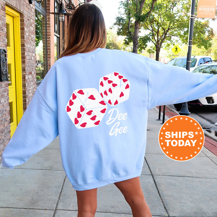 a woman walking down a sidewalk wearing a blue sweatshirt