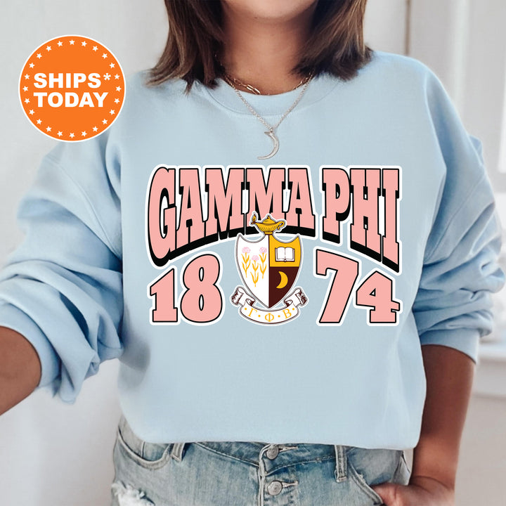 a woman wearing a blue sweatshirt with the words glamma phi on it