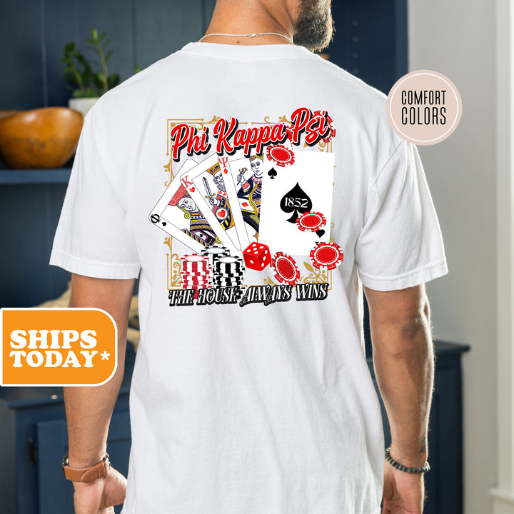 a man wearing a white shirt with a picture of playing cards on it