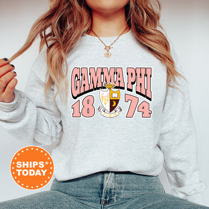 a woman wearing a gray sweatshirt with a graphic on it