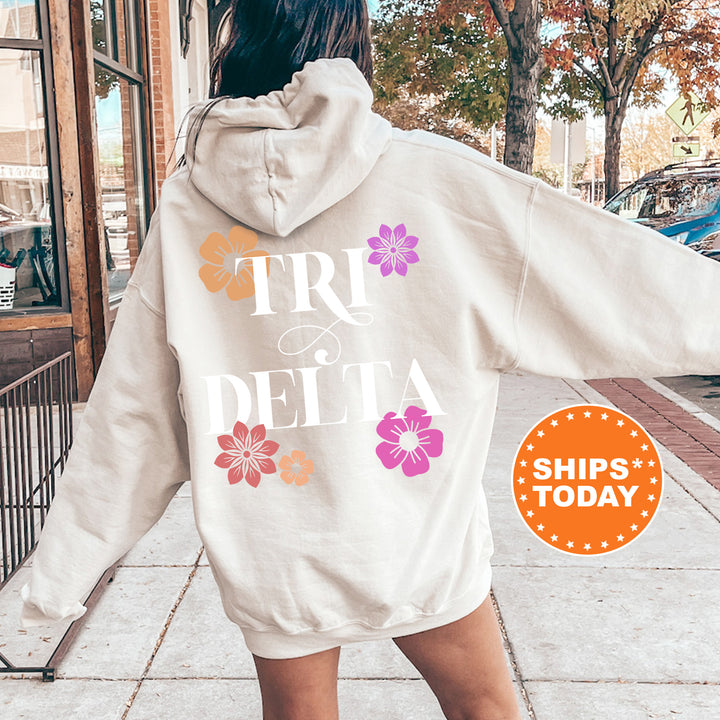 a woman walking down a sidewalk wearing a white hoodie