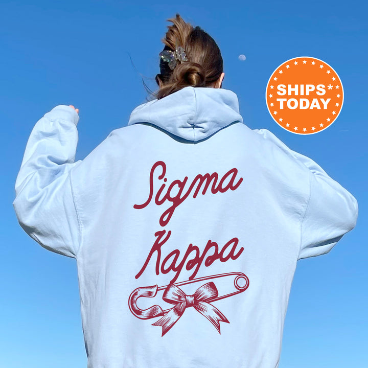 a woman wearing a white jacket with a red logo on it