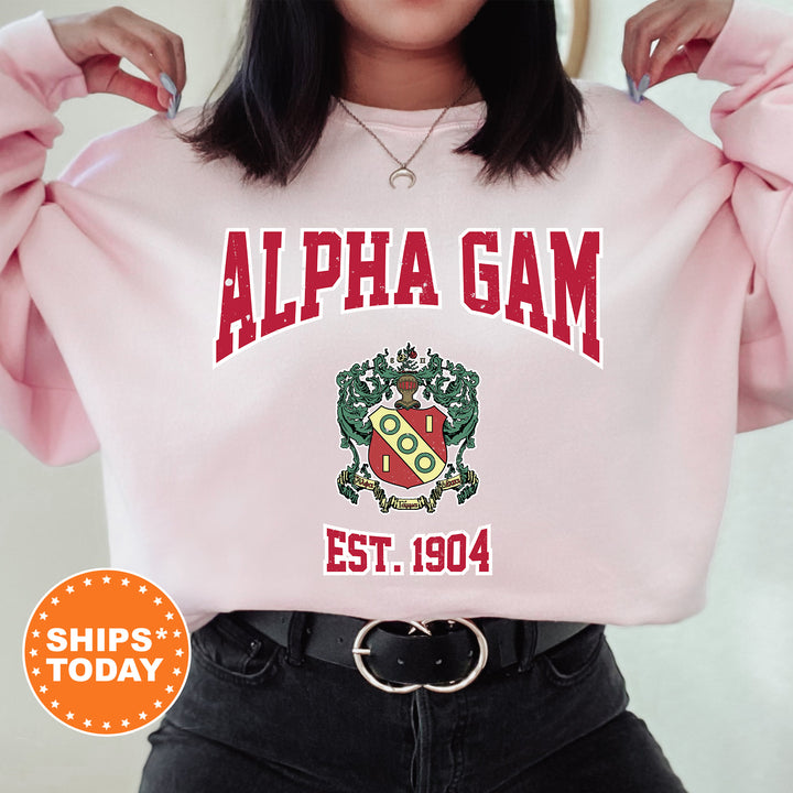a woman wearing a pink sweatshirt with the words alpha gam on it