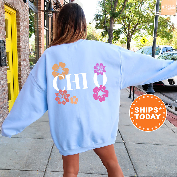 a woman walking down a sidewalk wearing a blue sweatshirt
