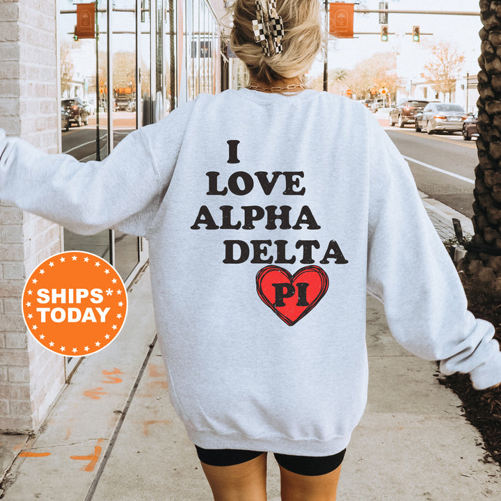 a woman walking down a sidewalk wearing a sweatshirt