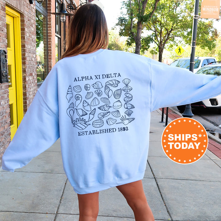 a woman walking down a sidewalk wearing a blue sweatshirt