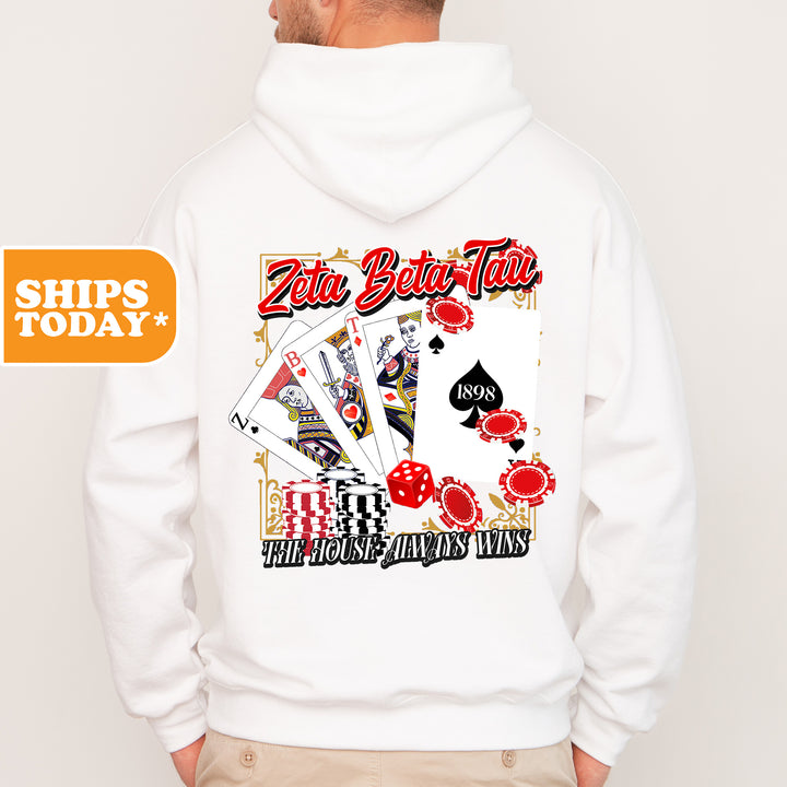 a man wearing a white hoodie with a picture of playing cards on it