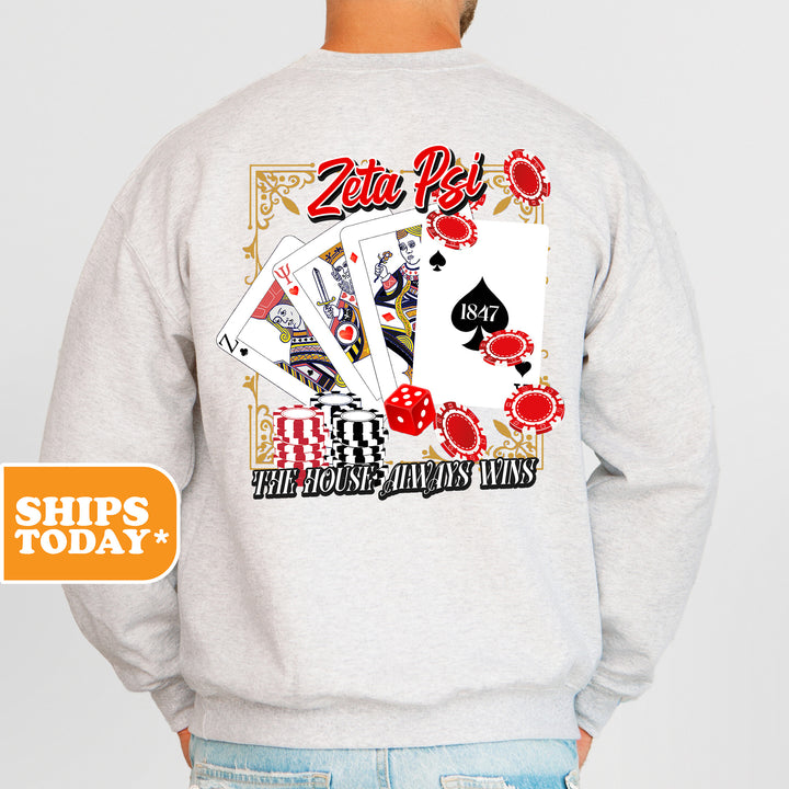 a man wearing a sweatshirt with a back print of playing cards