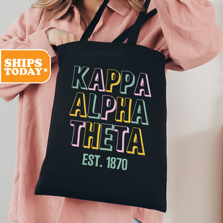 a woman holding a black tote bag with the words kapa aloha
