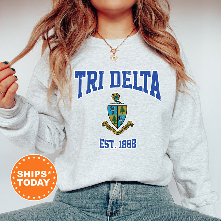 a woman wearing a sweatshirt that says tri delta