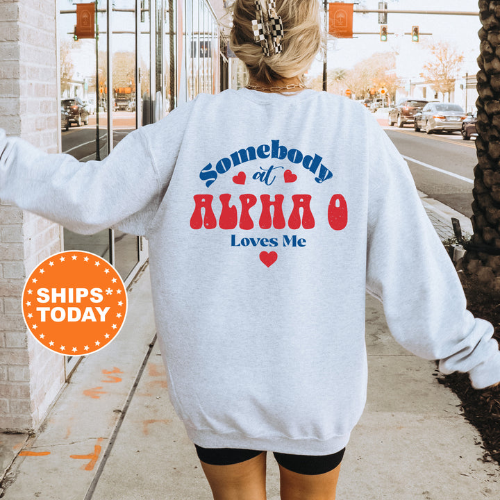 a woman walking down a sidewalk wearing a sweatshirt