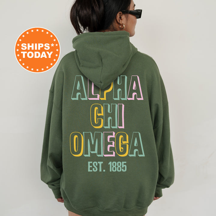 a woman wearing a green hoodie with the words aloha chi omega on