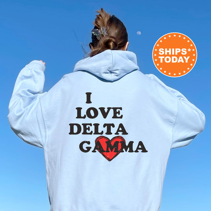 a woman wearing a white hoodie that says i love delta gama