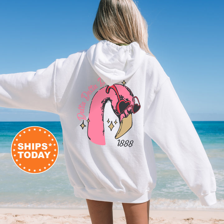 a woman standing on a beach with her back to the camera