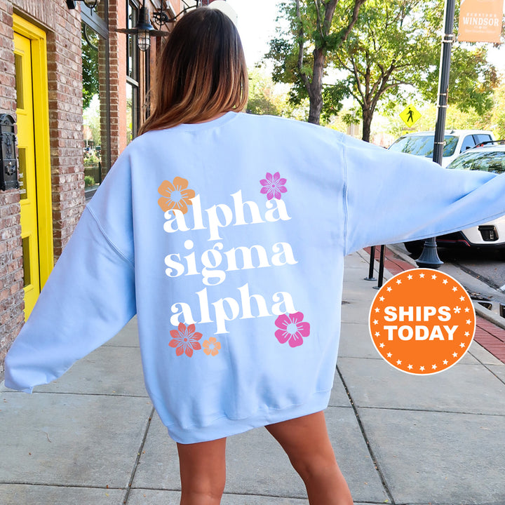 a woman walking down a sidewalk wearing a blue sweatshirt