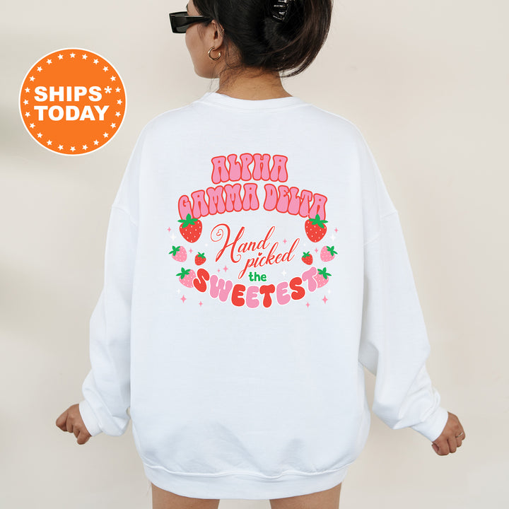 a woman wearing a white sweatshirt with a strawberry print on it