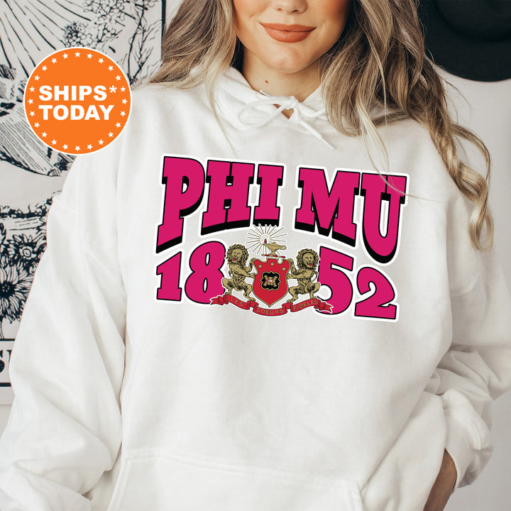 a woman wearing a white phi mu hoodie