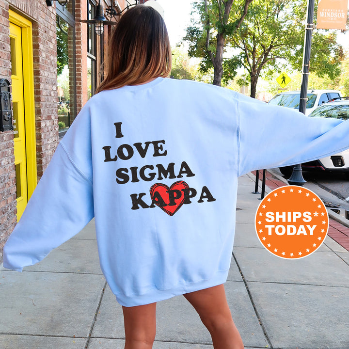 a woman walking down a sidewalk wearing a blue sweatshirt