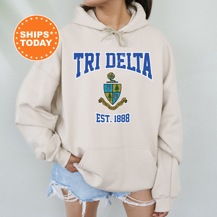 a woman wearing a white hoodie with the words tri delta on it
