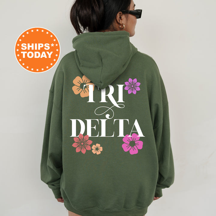 a woman wearing a green hoodie with flowers on it