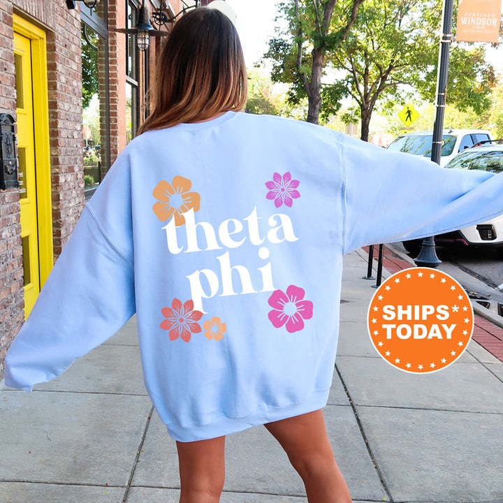 a woman walking down a sidewalk wearing a blue sweatshirt