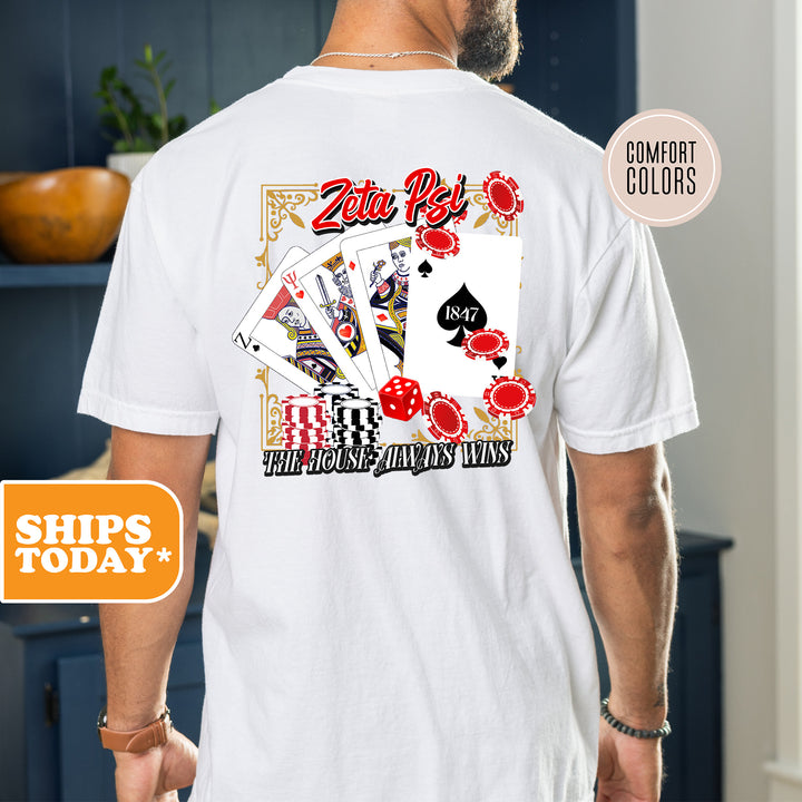 a man wearing a white shirt with a picture of playing cards on it