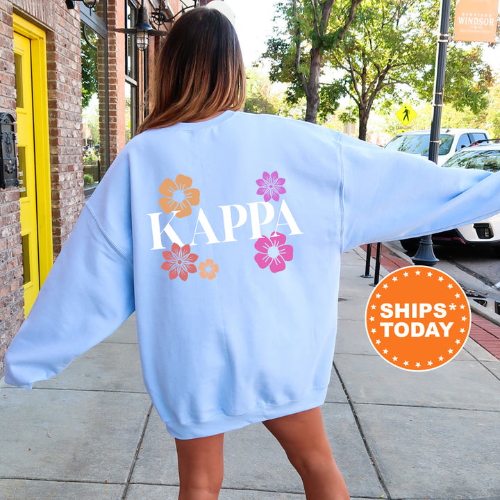 a woman walking down a sidewalk wearing a blue sweatshirt