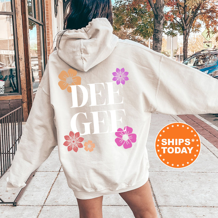 a woman walking down a sidewalk wearing a white hoodie