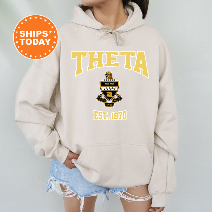 a woman wearing a sweatshirt with the words theta on it