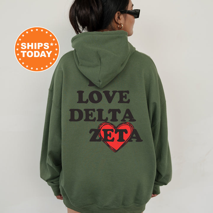 a woman wearing a green hoodie with the words love delta on it