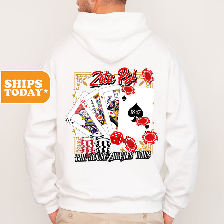 a man wearing a white hoodie with a picture of playing cards on it