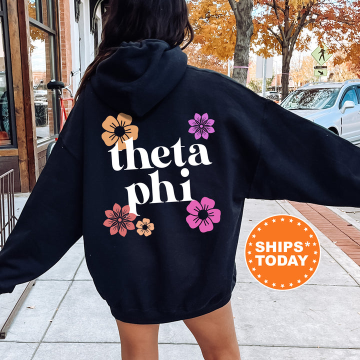 a woman in a black hoodie that says thea phi