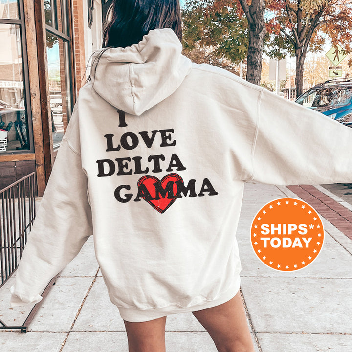 a woman in a white hoodie that says i love delta gama