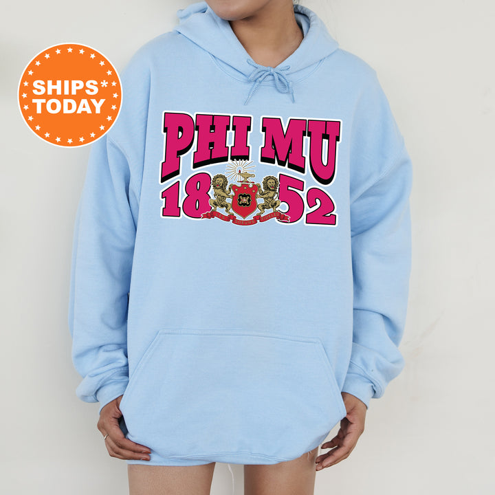 a woman wearing a blue phi mu hoodie