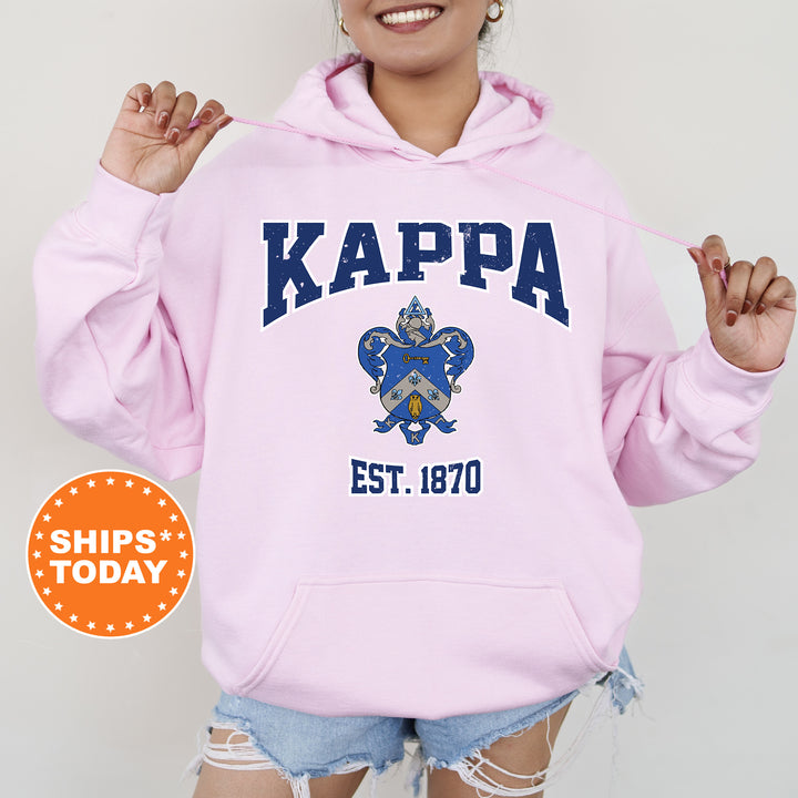 a woman wearing a pink kappa hoodie and ripped shorts