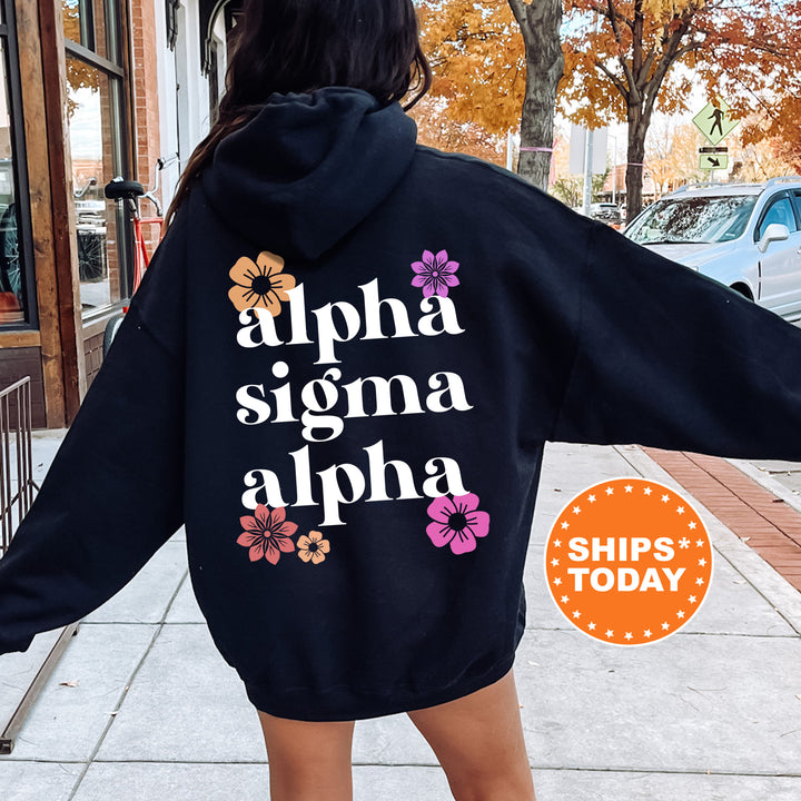 a woman wearing a black hoodie that says, aloha stigmaa al