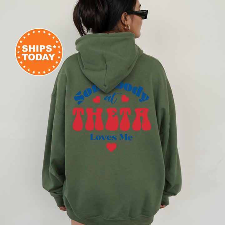 a woman wearing a green hoodie with a red heart on it