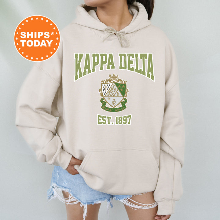 a woman wearing a hoodie with the words kapa delta on it