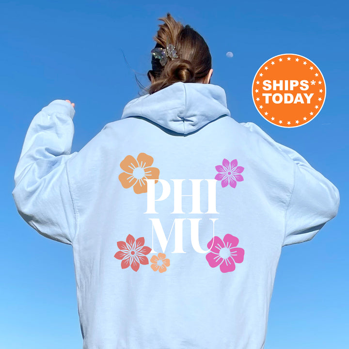 a woman wearing a white hoodie with flowers on it