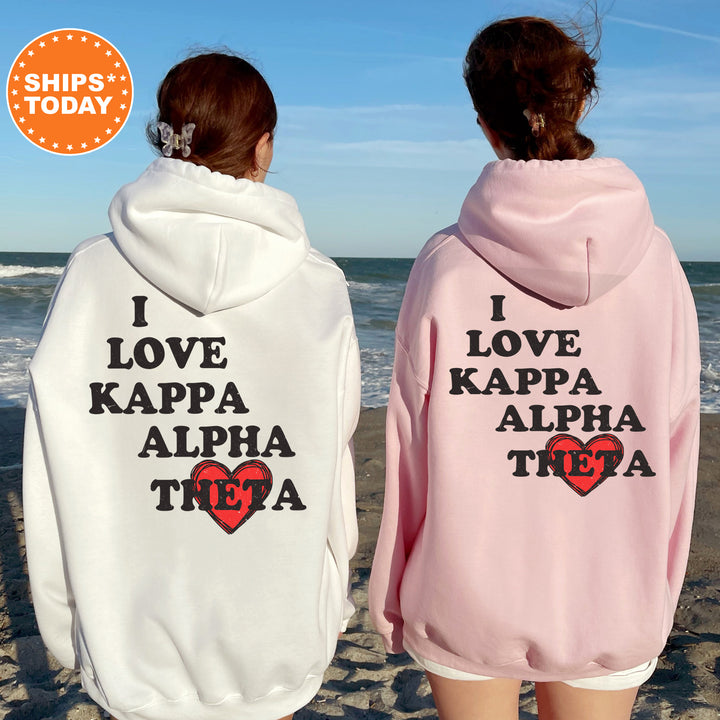 two women wearing matching sweatshirts on the beach