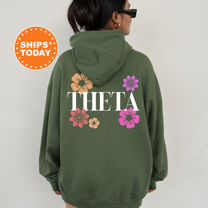 a woman wearing a green hoodie with flowers on it