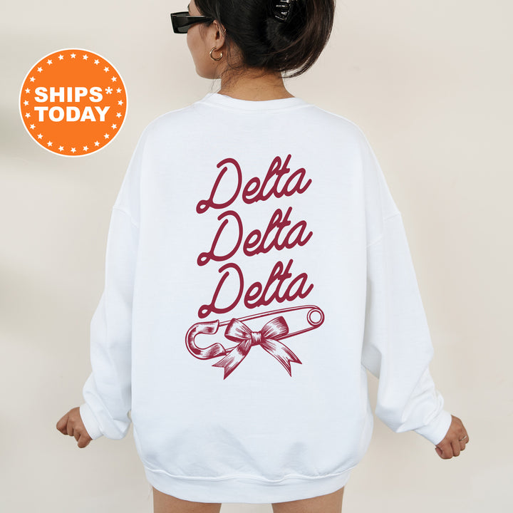 a woman wearing a white sweatshirt with the words delta delta on it