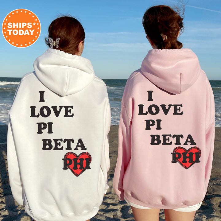 two women wearing matching sweatshirts on the beach