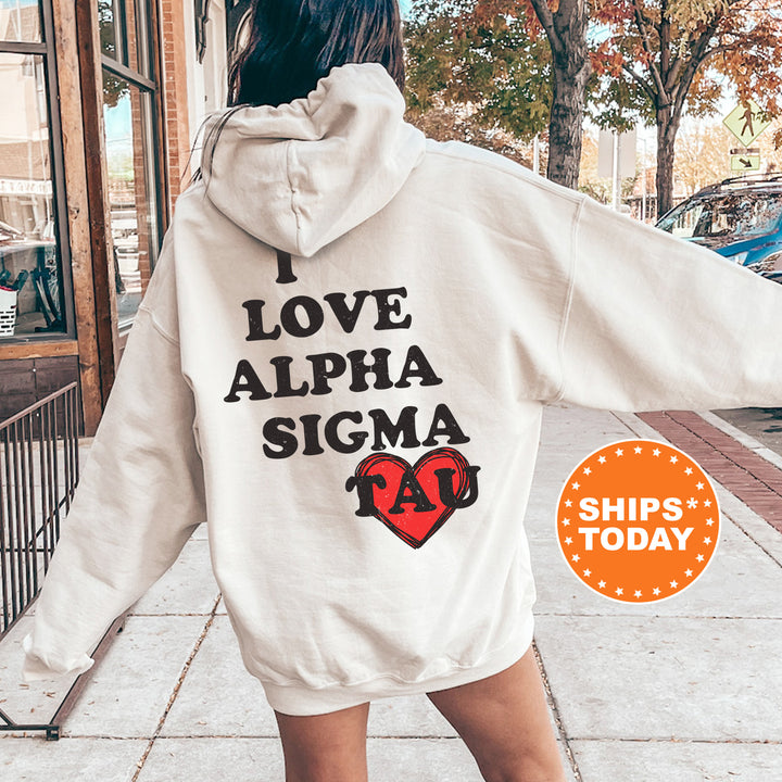 a woman walking down a sidewalk wearing a white hoodie