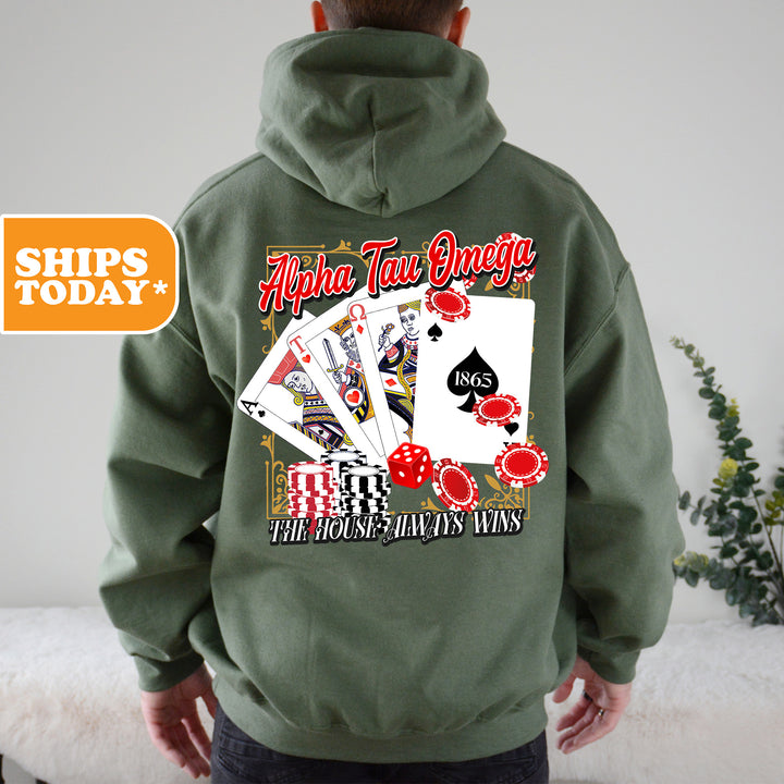 a man wearing a green hoodie with a picture of a playing card on it