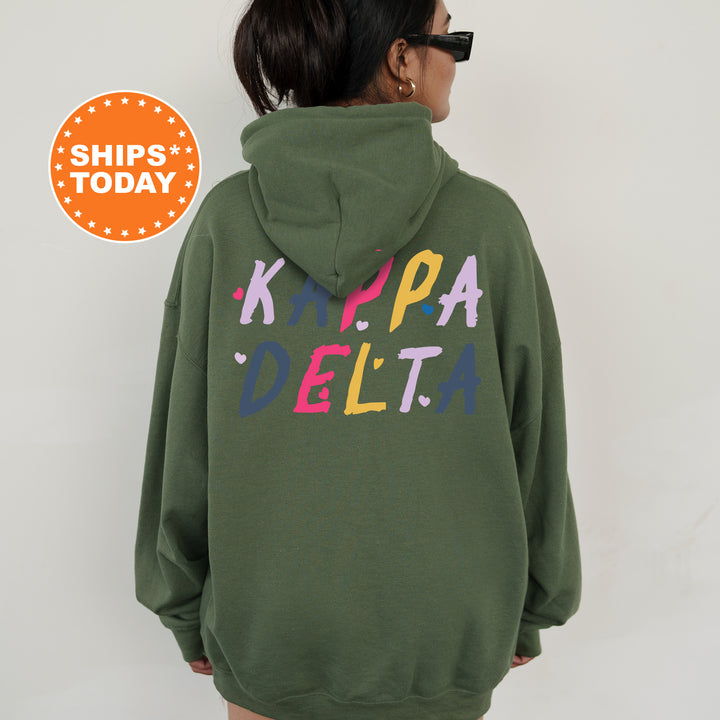 a woman wearing a green hoodie with the words kappa delta printed on it