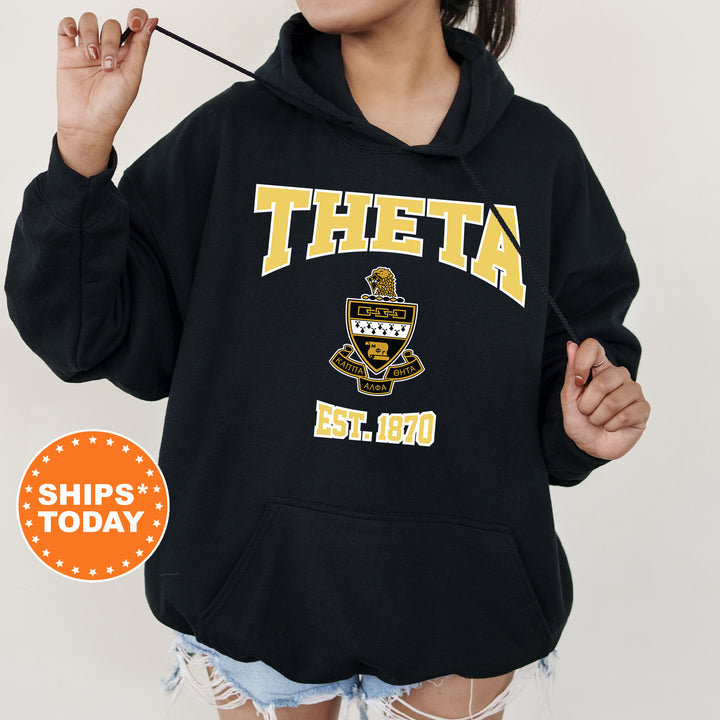 a woman wearing a black hoodie with a yellow and black logo