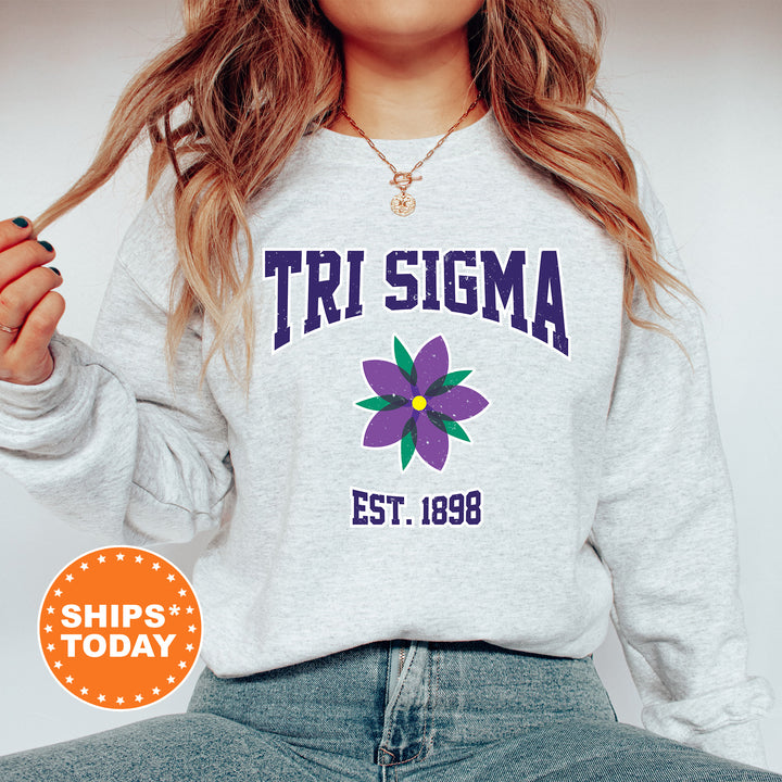 a woman wearing a sweatshirt with a flower on it