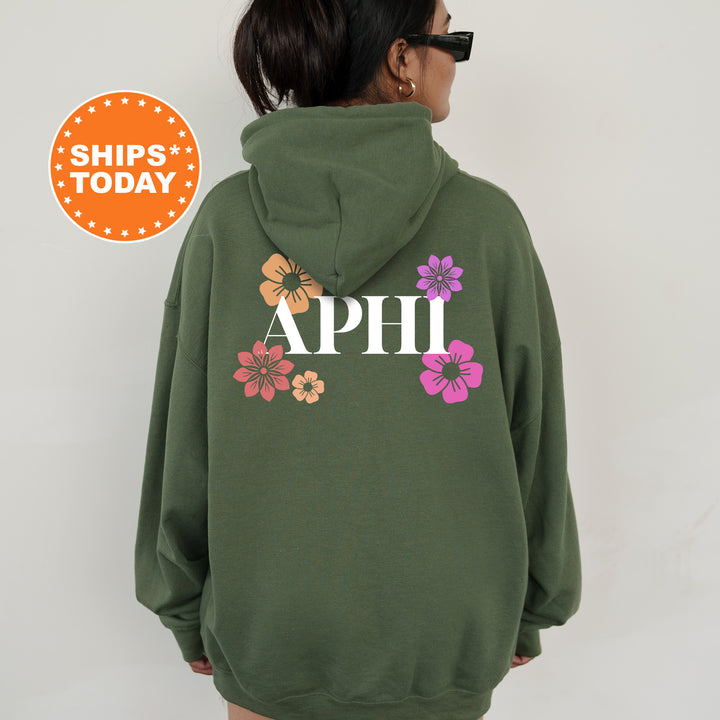 a woman wearing a green hoodie with flowers on it