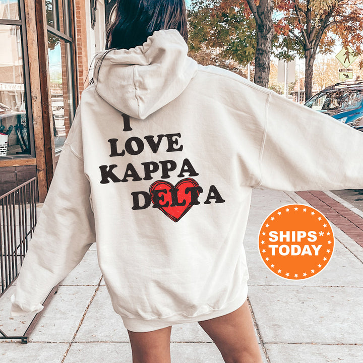 a woman in a white hoodie that says i love kappa dega